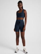 blue high-waisted 5" inseam biker shorts with pockets and a drawstring at waistband.