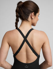 black midi length jumpsuit with cross straps on back.