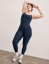 blue midi length jumpsuit with cross straps on back.