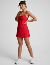 red mini dress with thin straps and built-in shorts with pockets.