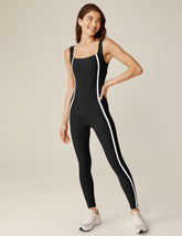 black square neck tank top midi jumpsuit with white lining on the sides.