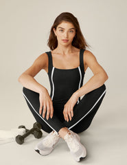 black square neck tank top midi jumpsuit with white lining on the sides.