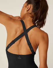 black biker jumpsuit with a crossover strap detail in the back and pockets.