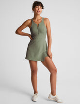 green mini active dress with a zipper on the front neckline and a side slit.