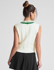 white relaxed fit cable knit vest with a neckline with contrast color stripe, rib hemband, neckline and armholes.