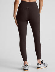 model wearing brown ribbed high-waisted midi length leggings against a plain background.