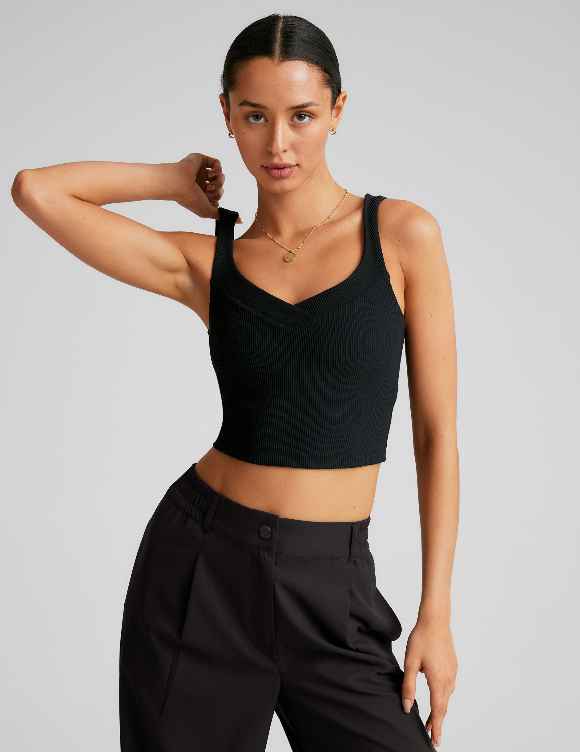 black ribbed cropped tank with a front and back v neckline.