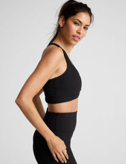 black ribbed racerback bra with overlapping hemband detail​ and a scoop neckline.