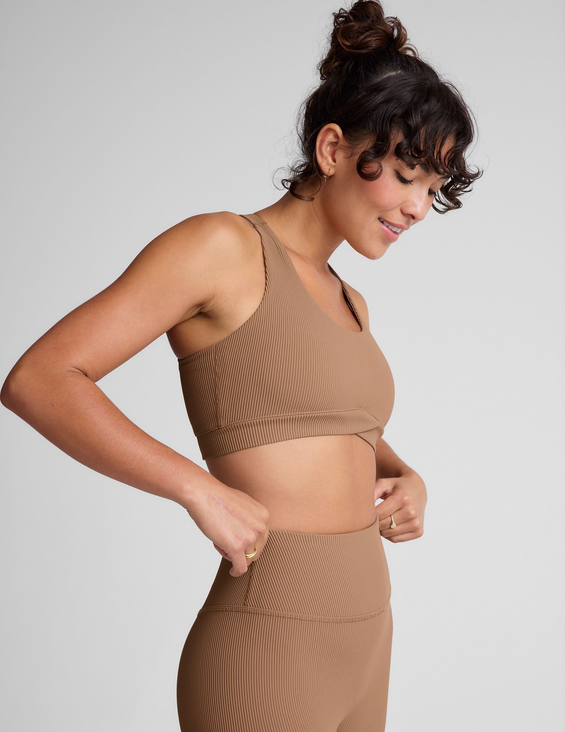 brown ribbed racerback bra with overlapping hemband detail and a scoop neckline.