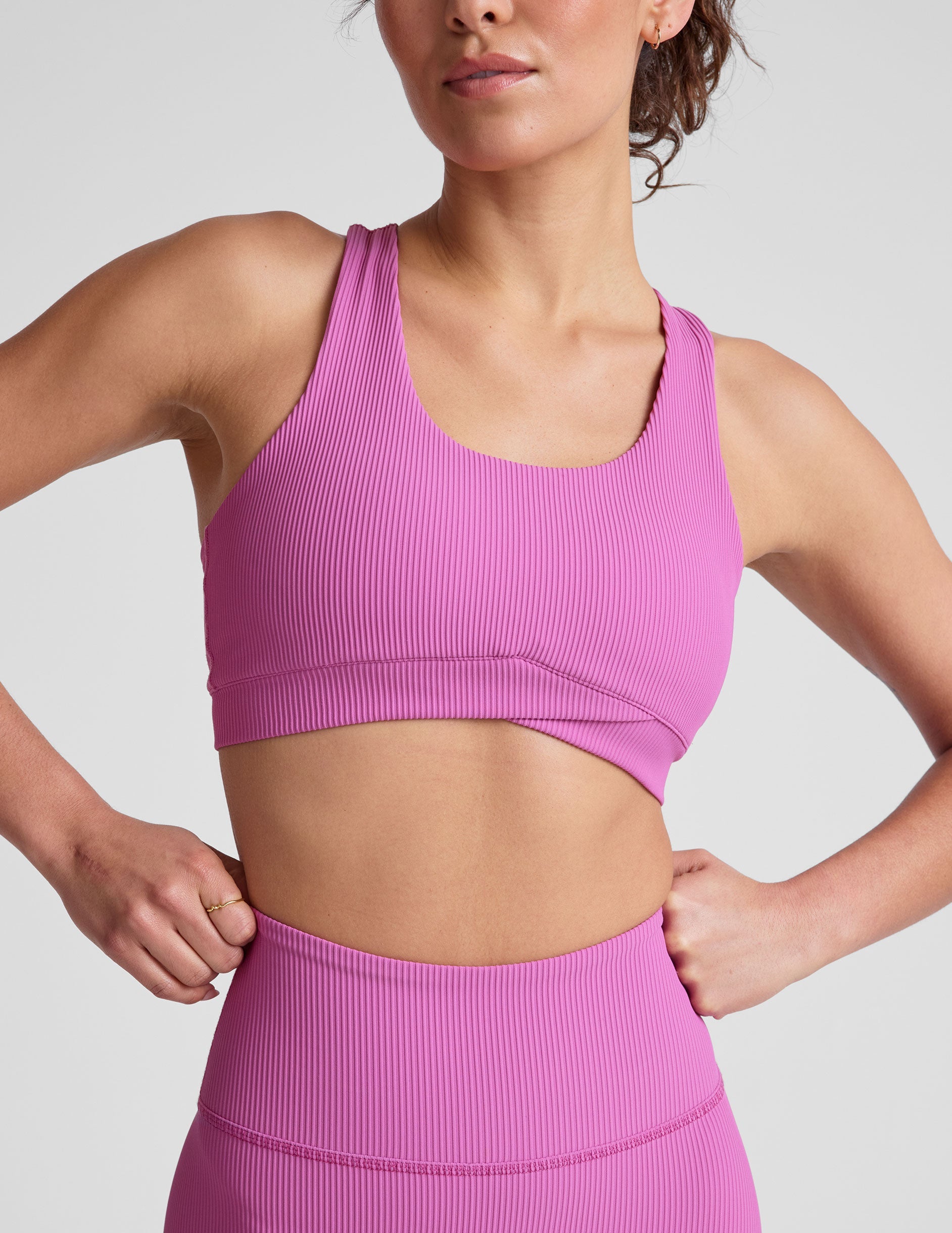 pink medium support racerback bra with a scoop neckline​, overlapping hemband detail​, is lined with performance lining and powermesh in between​, and has removable bra pads​. 