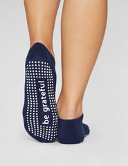 blue ankle length grip socks.