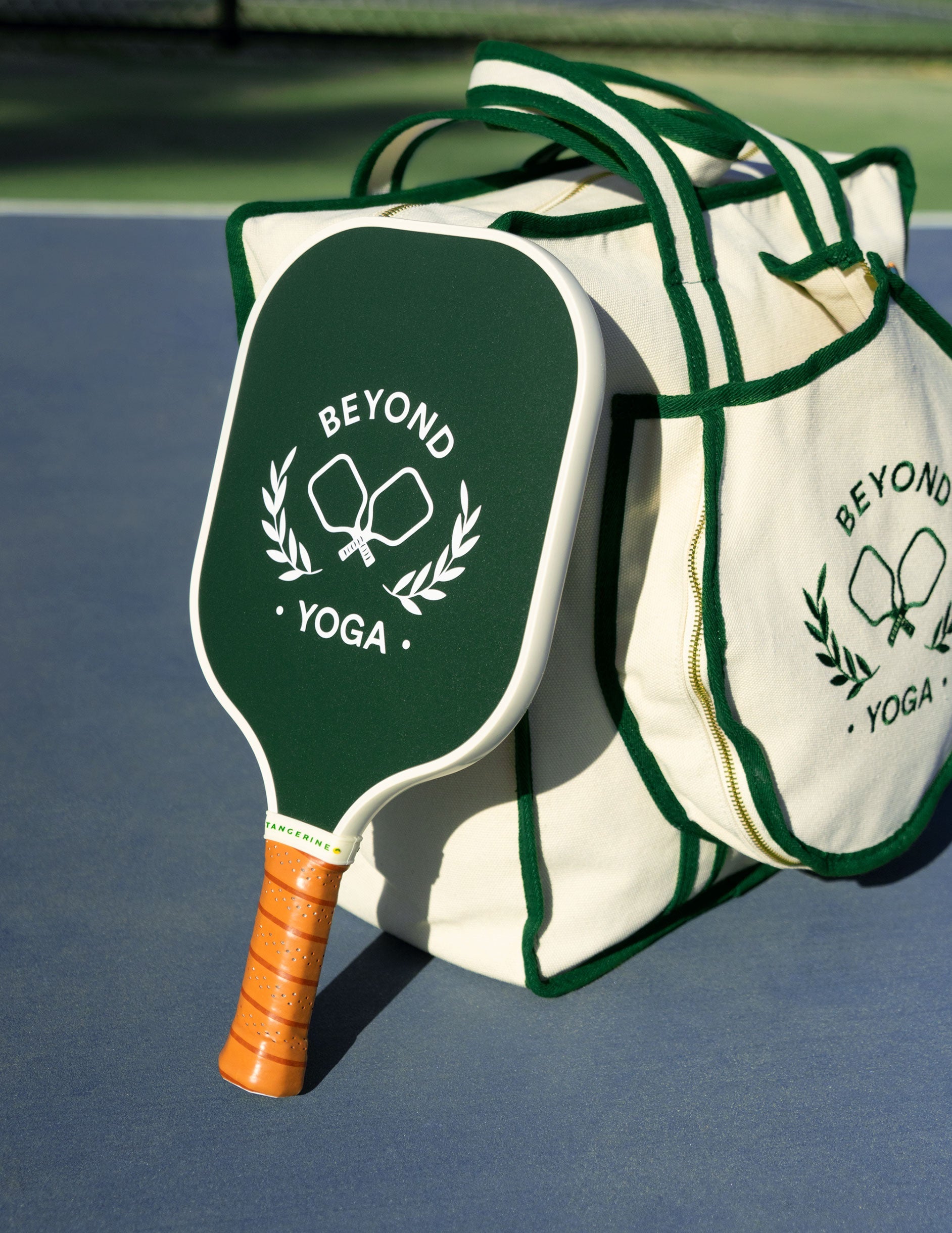 beyond yoga green and white stripped pickle-ball paddle.