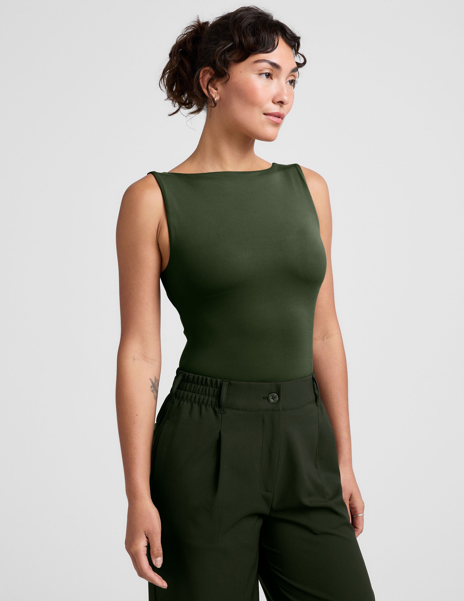 green boat neck tank top with a square back neckline.