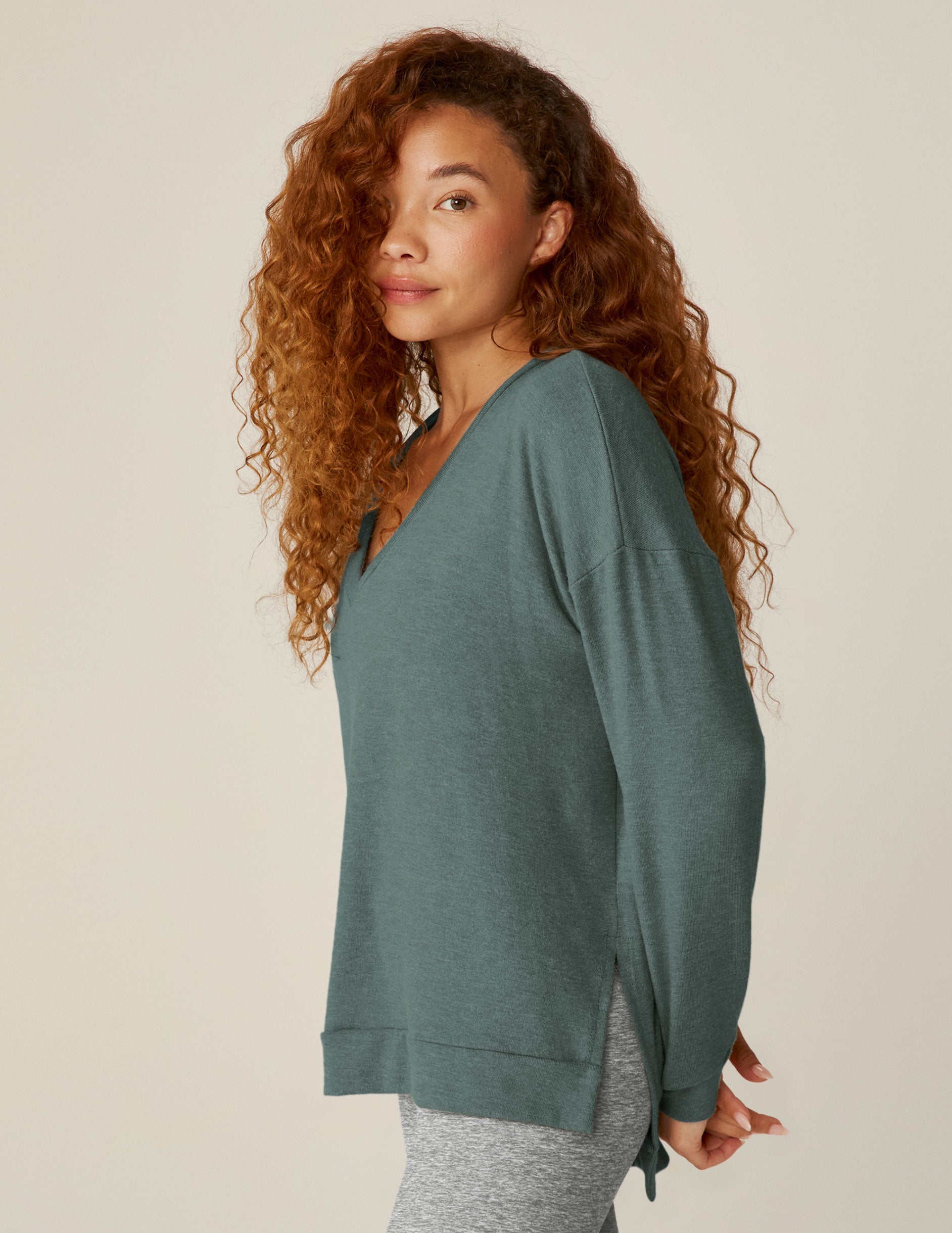 blue v-neck pullover sweater with a high-low detail at waistband and side slits.