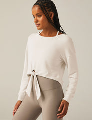 white scoop neck cropped pullover with a front tie detail.