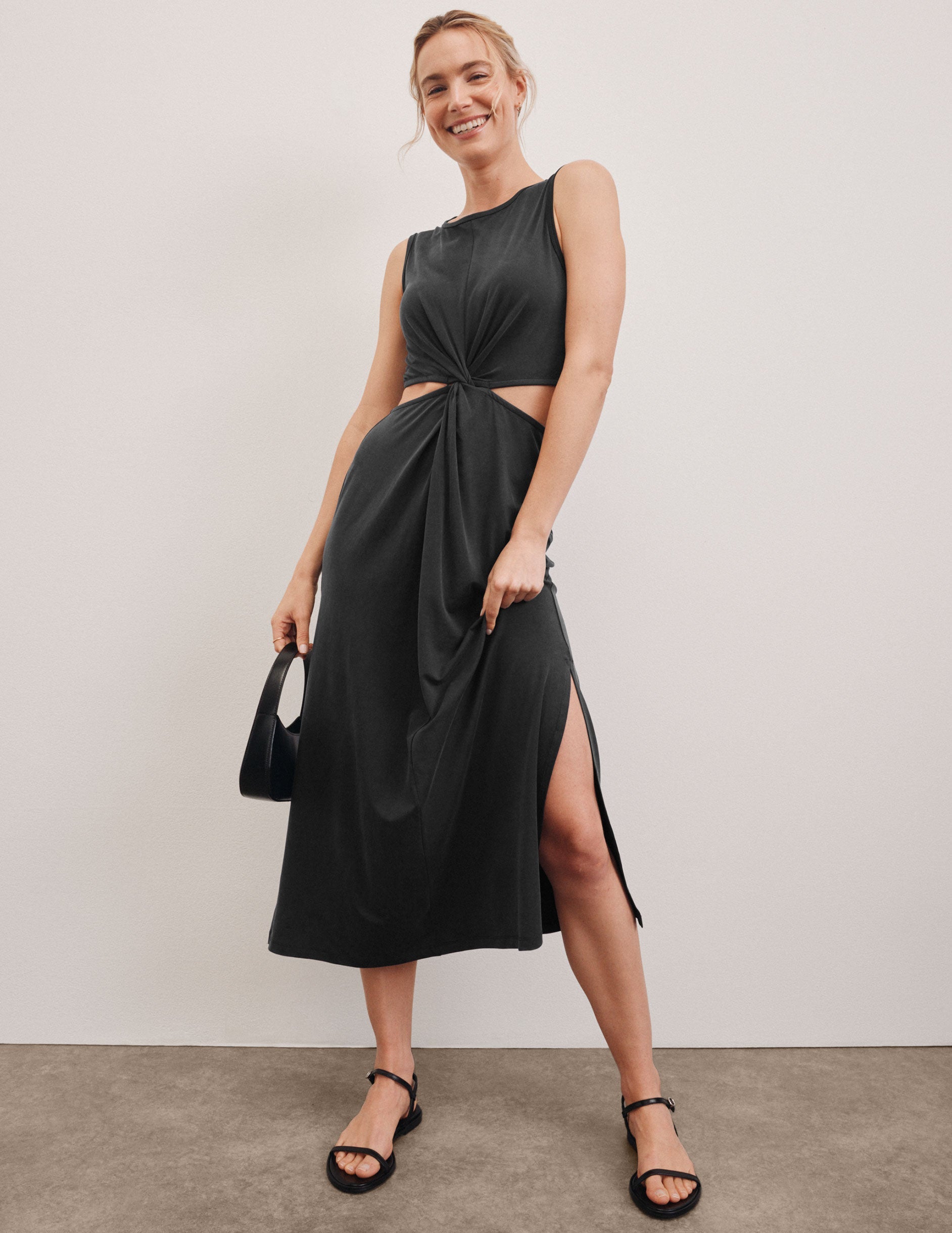 black maxi dress with cutouts at the waist.