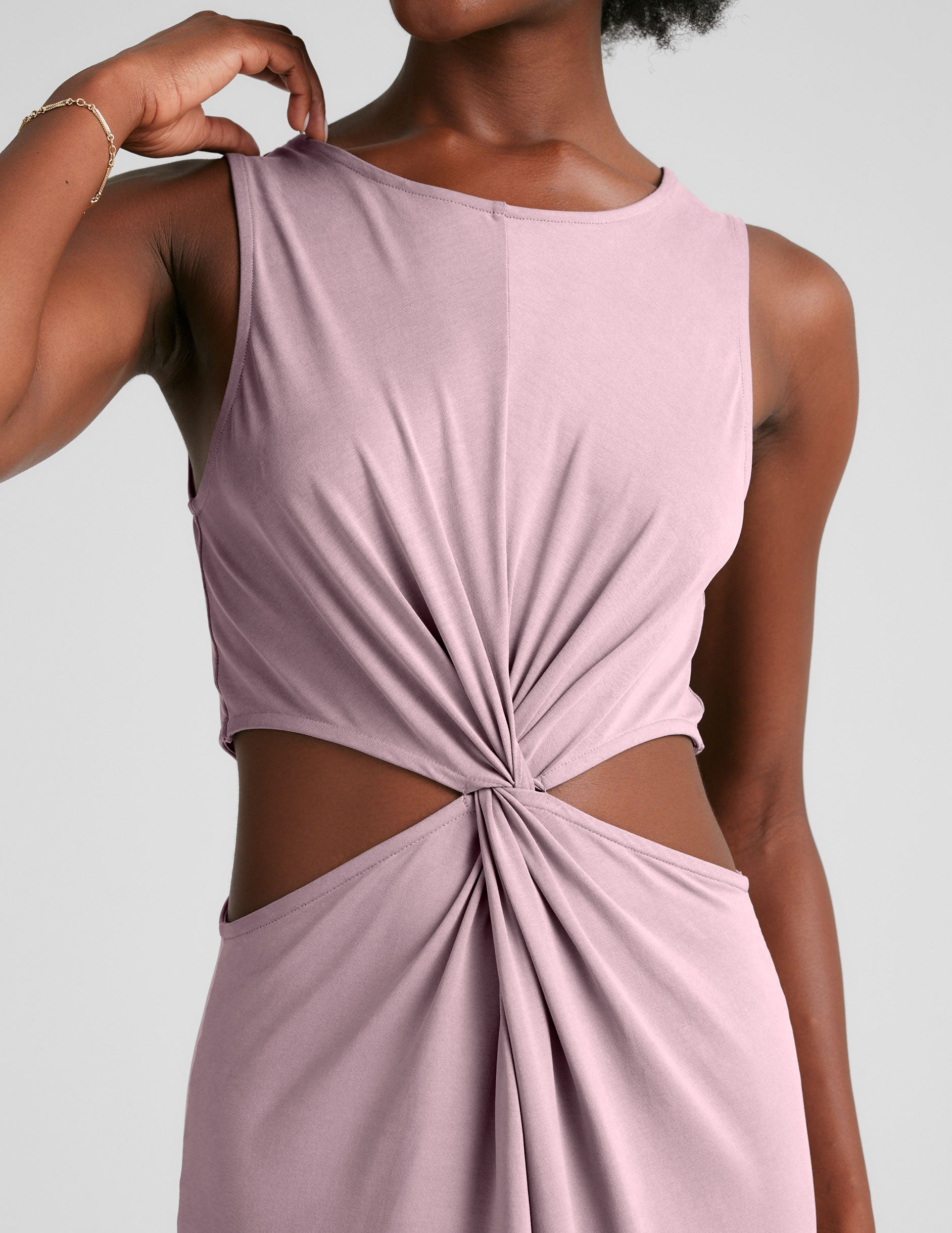 pink midi length tank dress with a scoop neckline and cutouts at waistband.