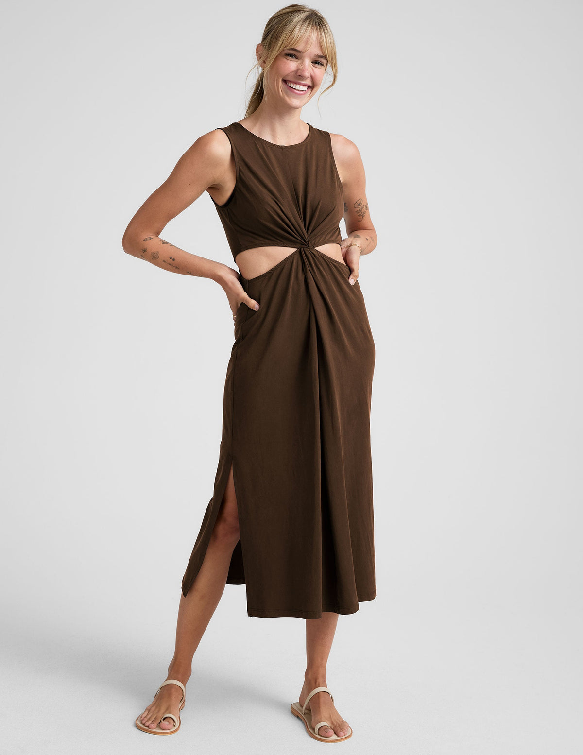 brown midi length tank dress with side slits and cutouts at waist.