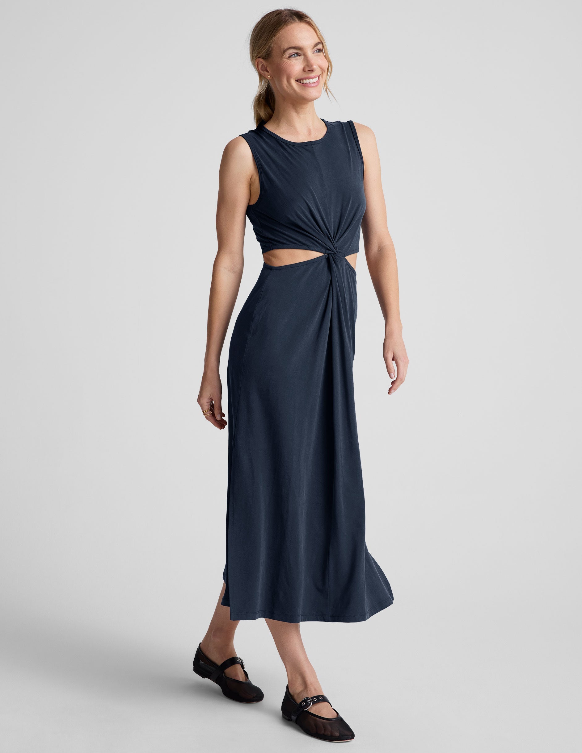blue midi length thick strap tank dress with cutouts on sides of the waist and side slits on both sides of leg.