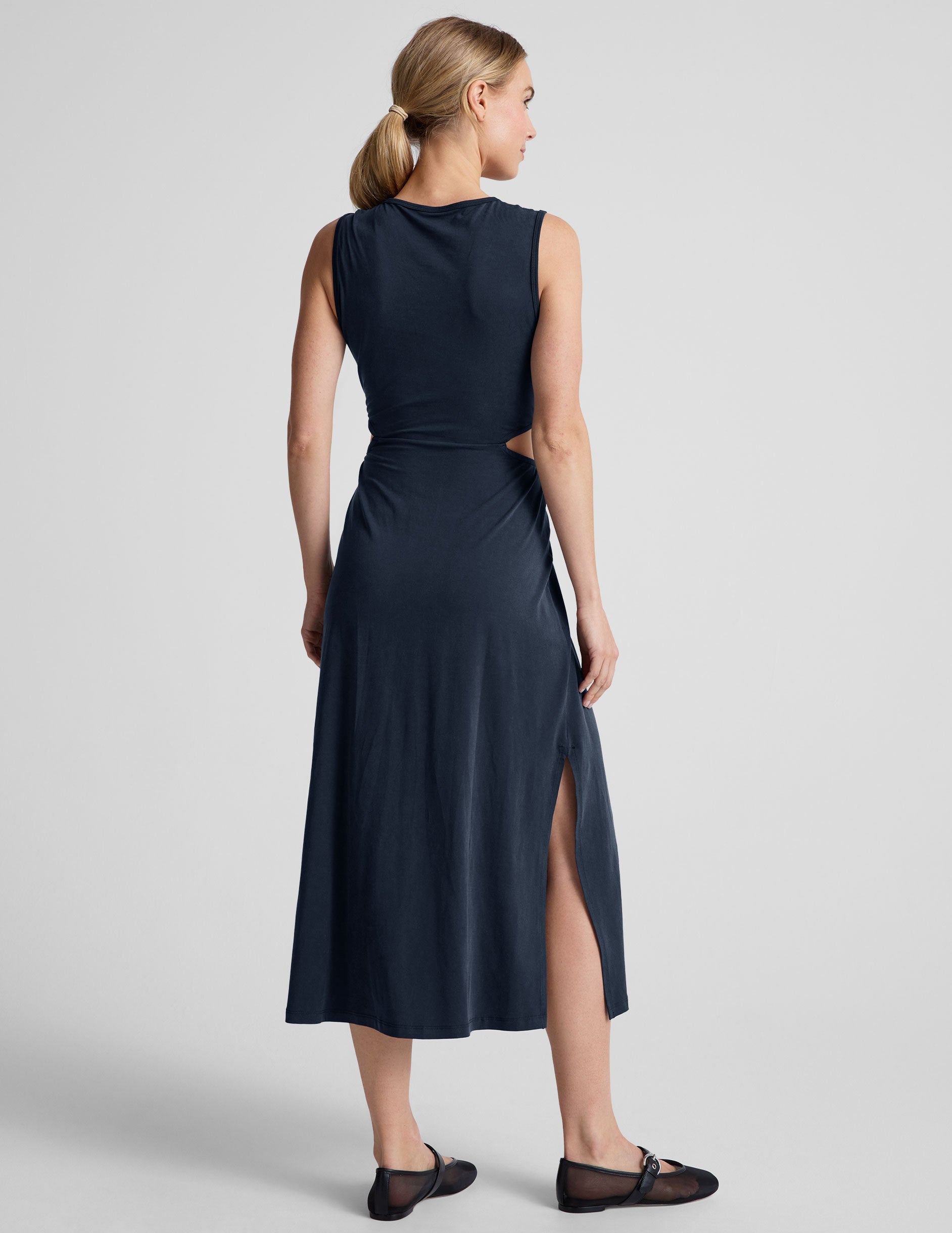 blue midi length thick strap tank dress with cutouts on sides of the waist and side slits on both sides of leg.