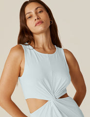 model is wearing a blue tank top maxi dress with a twist detailing and side cutouts.