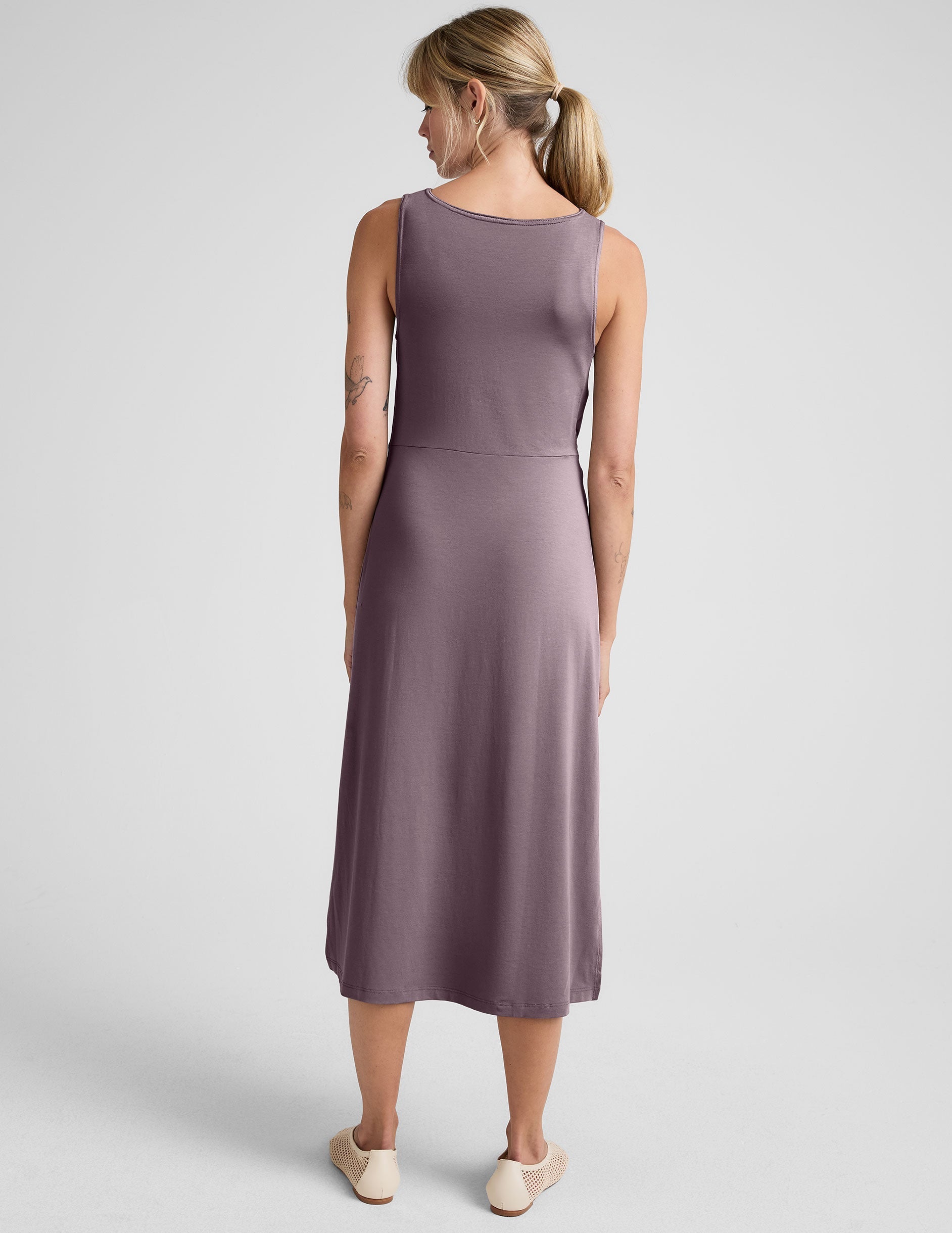 brown midi length dress with a side twist detail and side slit.