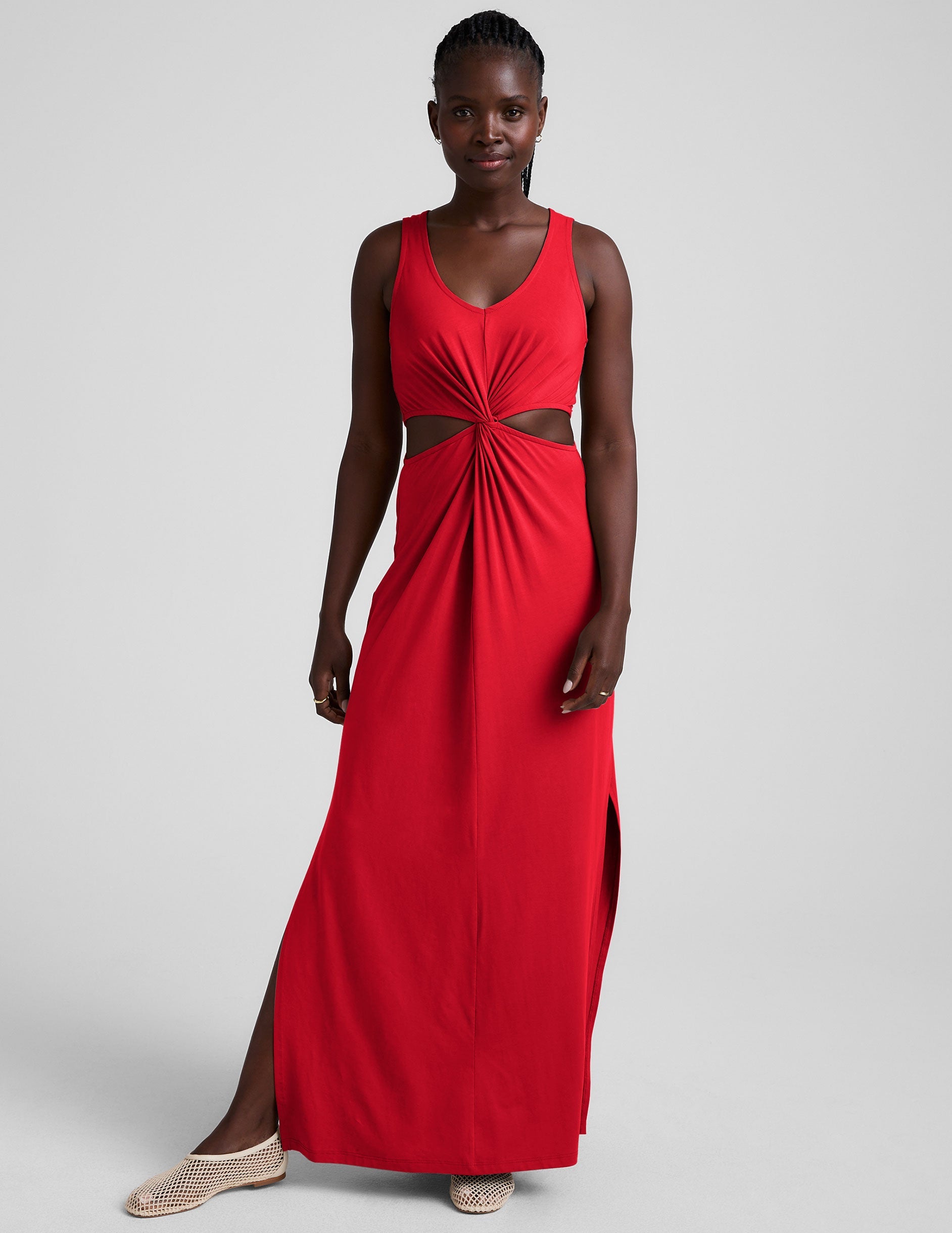red maxi length tank dress with a v neckline and cutouts at waist.