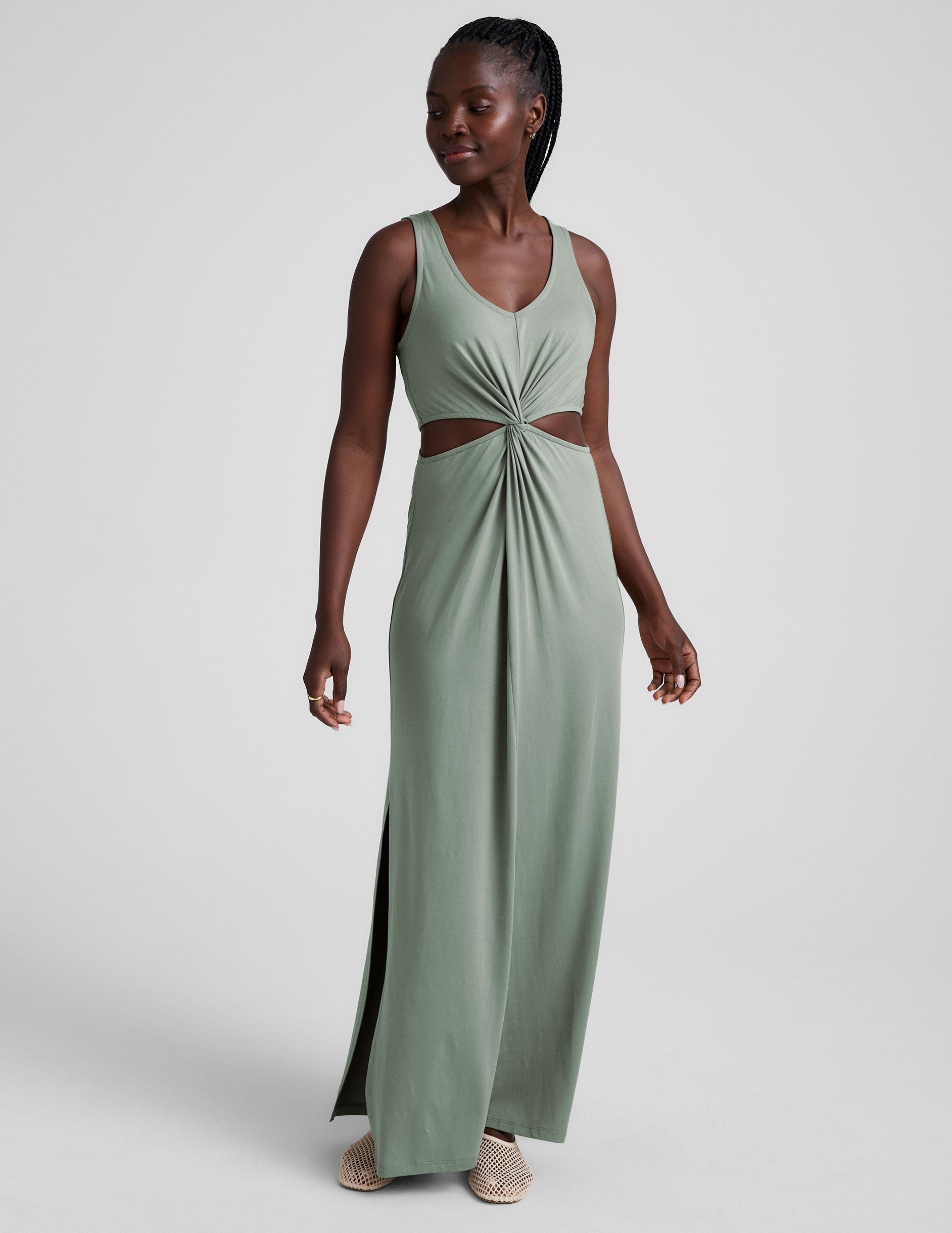 green v-neck maxi length tank dress with cutouts at the waist.