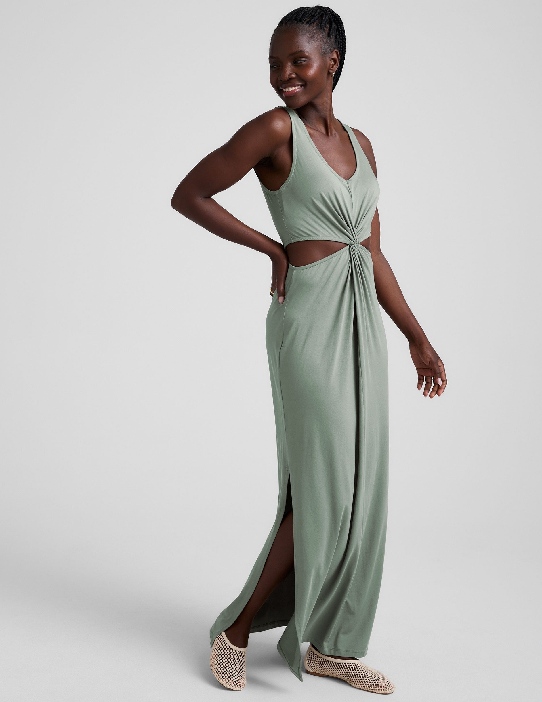 green v-neck maxi length tank dress with cutouts at the waist.