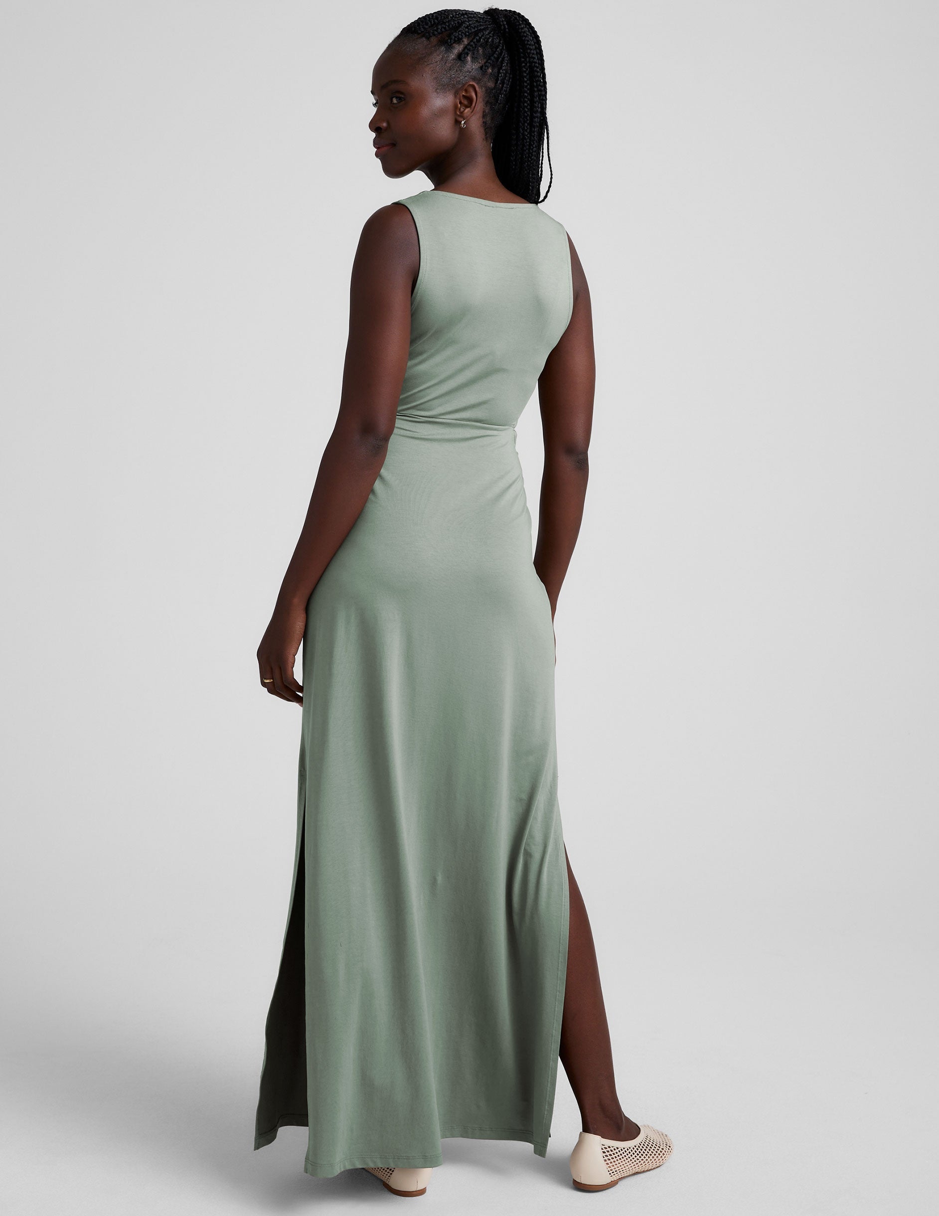 green v-neck maxi length tank dress with cutouts at the waist.