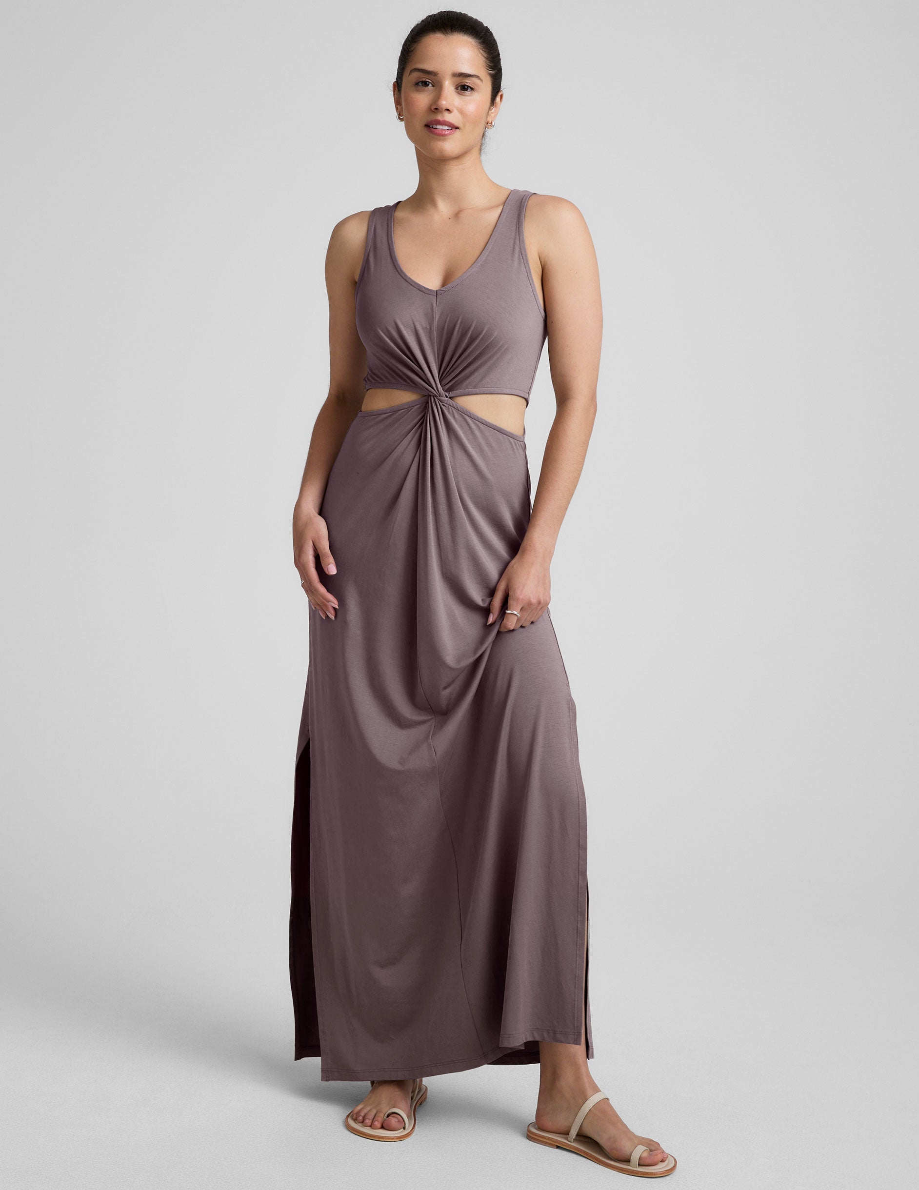 brown v-neck tank maxi length dress with cutouts at the waist.