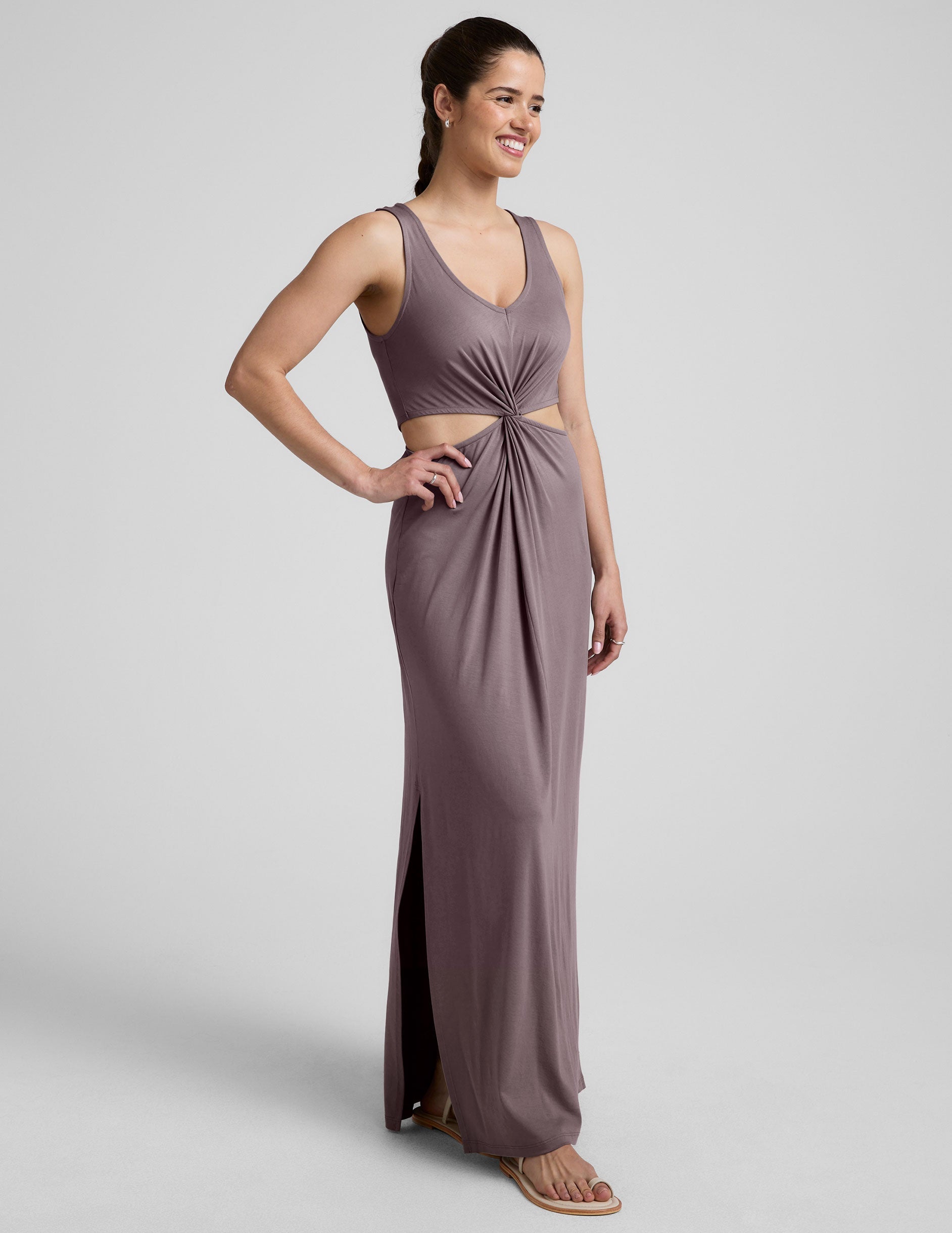 brown v-neck tank maxi length dress with cutouts at the waist.