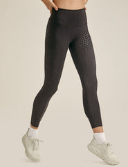 black high-waisted midi length leggings with a shimmering heart pattern.