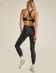 black high-waisted midi length leggings with a shimmering heart pattern.