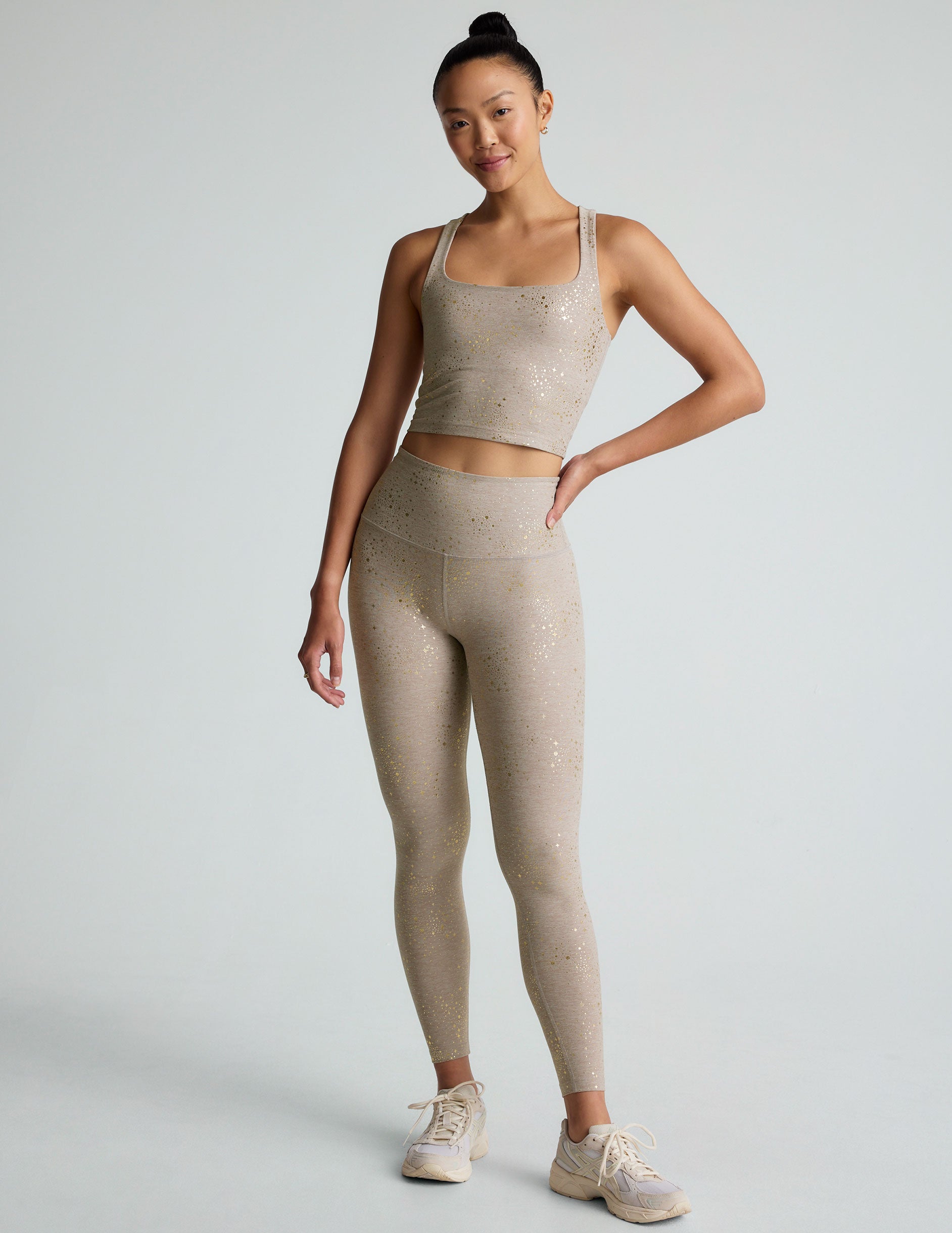 brown high-waisted midi length leggings with a star shine print.