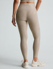 brown high-waisted midi length leggings with a star shine print.