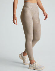 brown high-waisted midi length leggings with a star shine print.