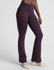person wearing dark purple pants on a light gray background.