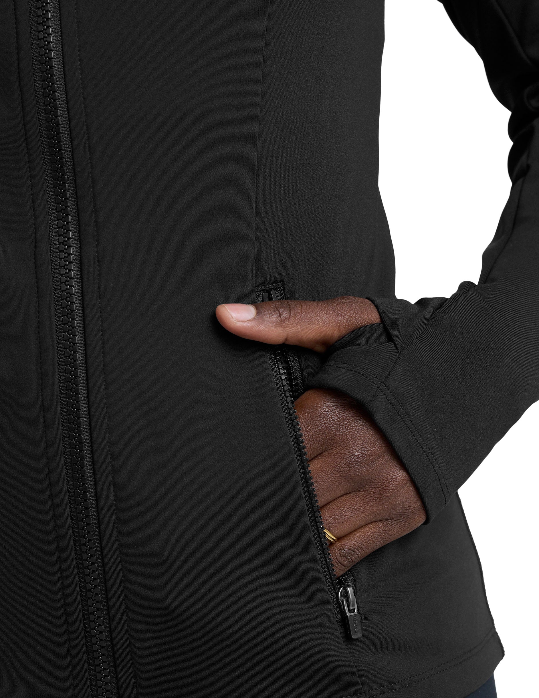 woman in black zip-up hooded jacket and leggings against a plain background.