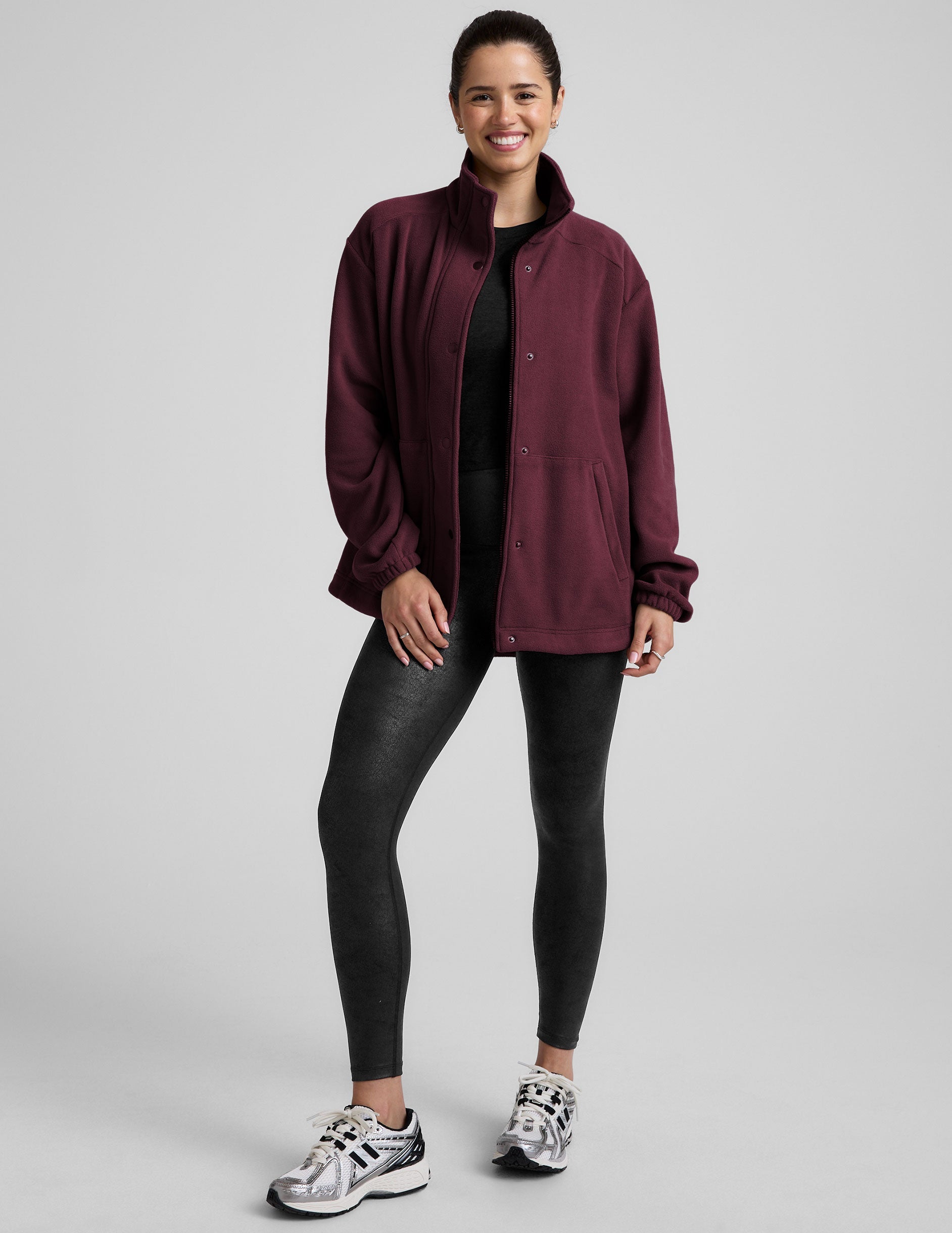 red fleece button up jacket with a full front zip and snap closures and pockets.