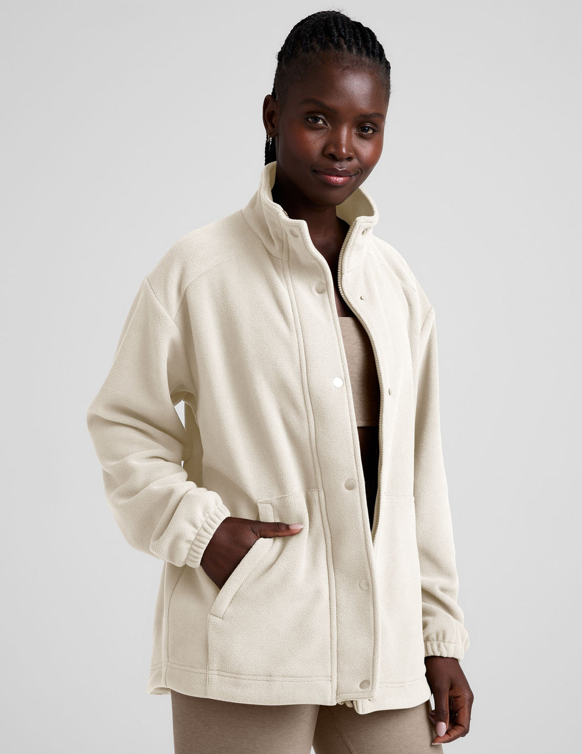 white fleece button up jacket with a full front zip and snap closures and pockets.