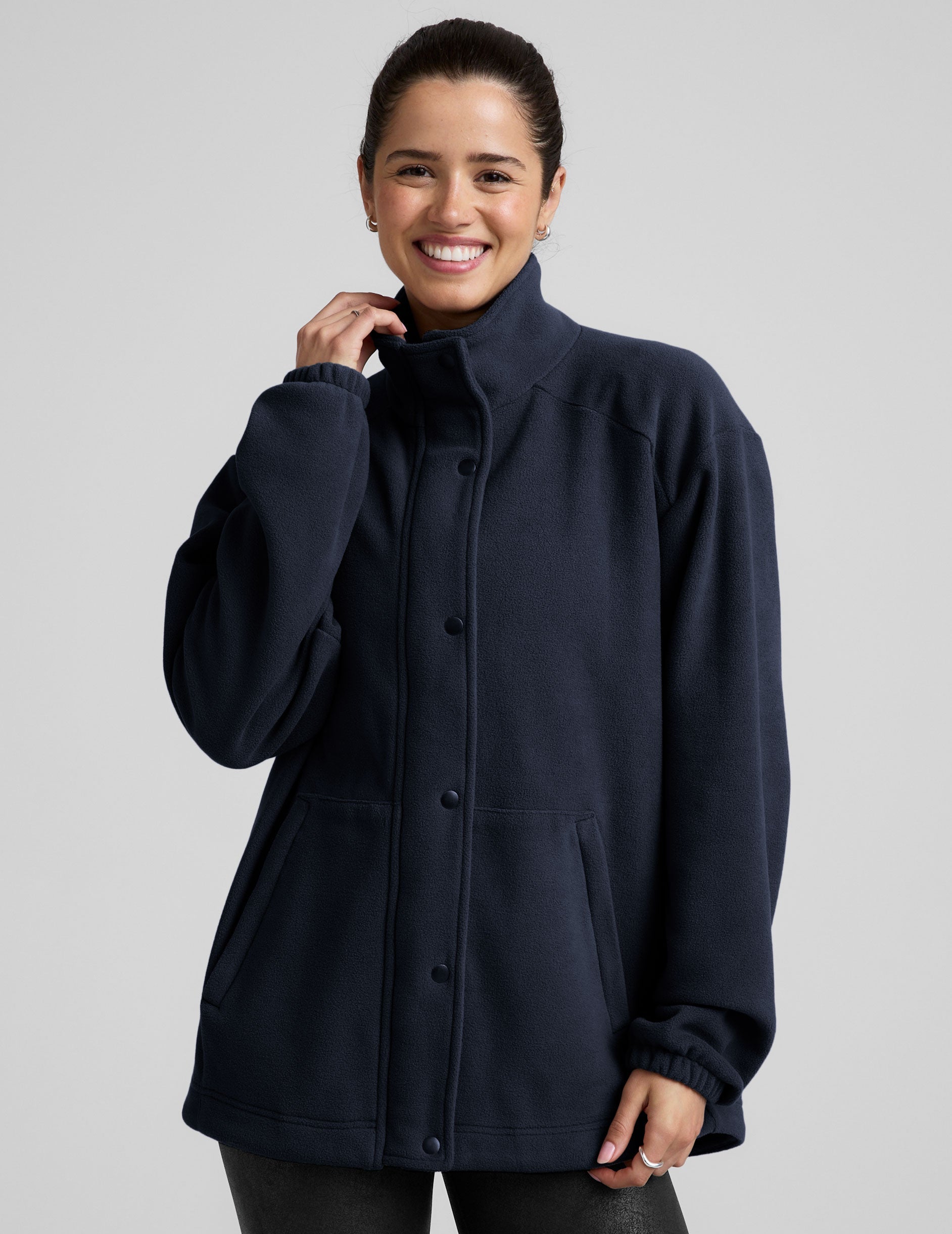 blue fleece button up jacket with a full front zip and snap closures and pockets.