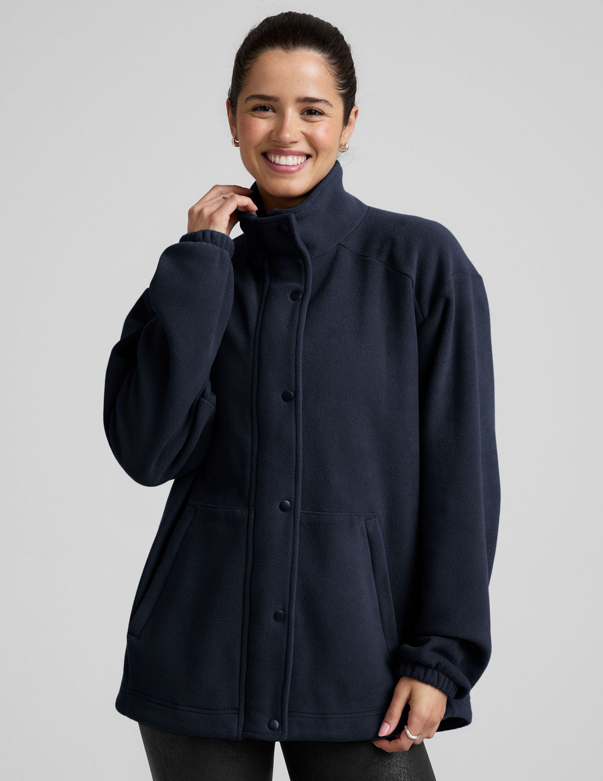blue fleece button up jacket with a full front zip and snap closures and pockets.