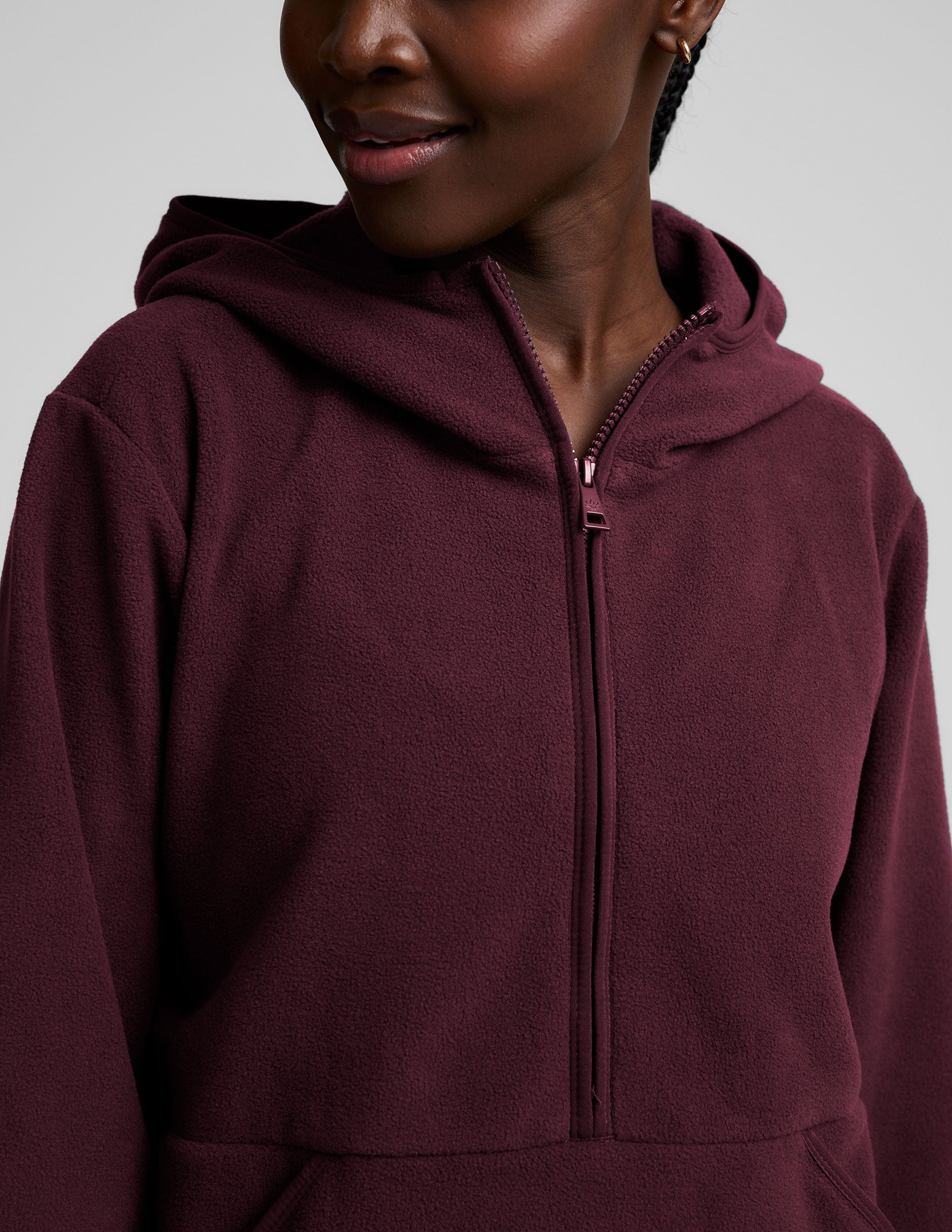 red fleece quarter zip jacket with a kangaroo pocket.