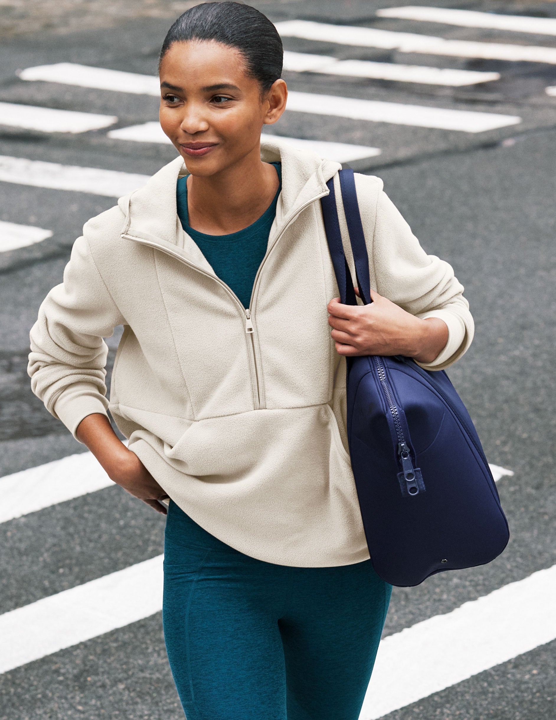 white fleece quarter zip jacket with a kangaroo pocket.
