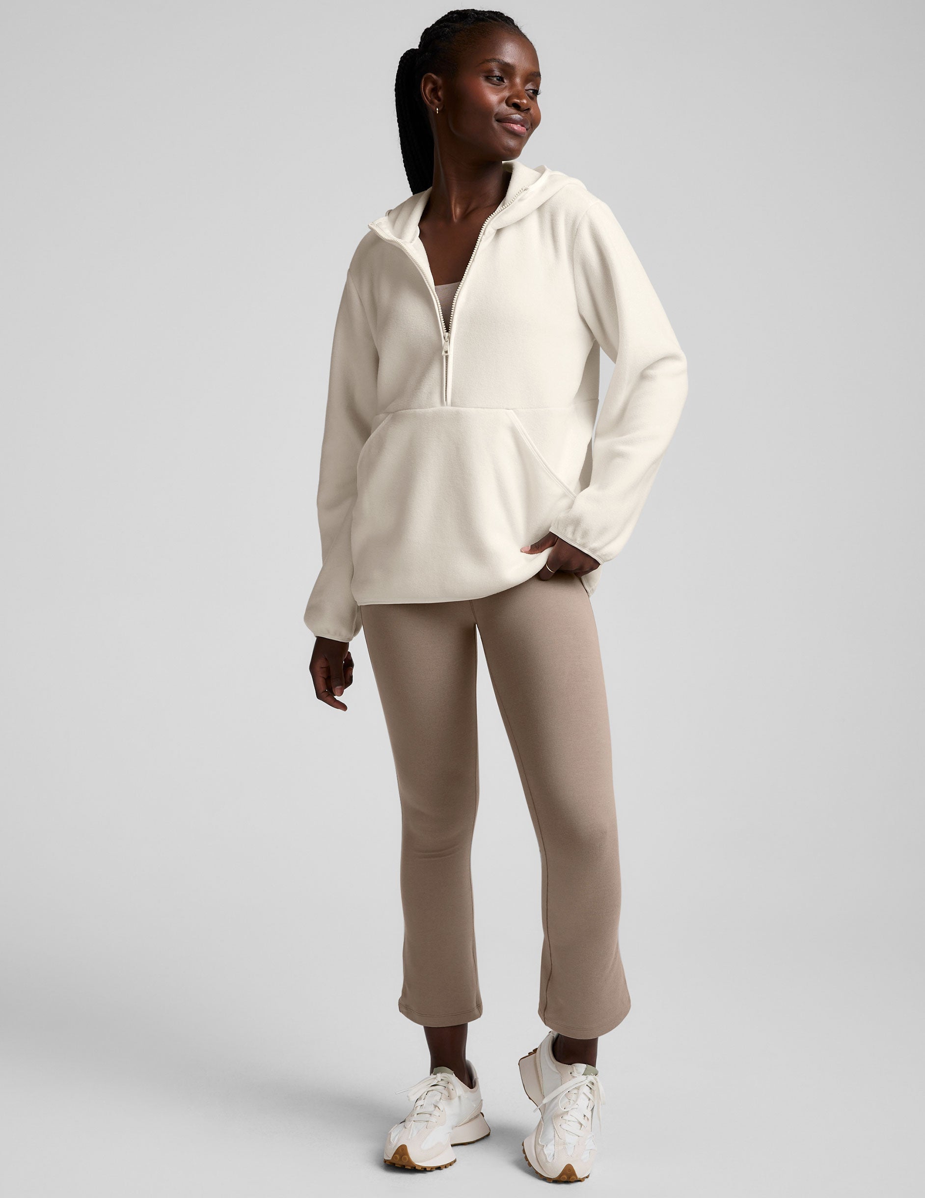 white fleece quarter zip jacket with a kangaroo pocket.