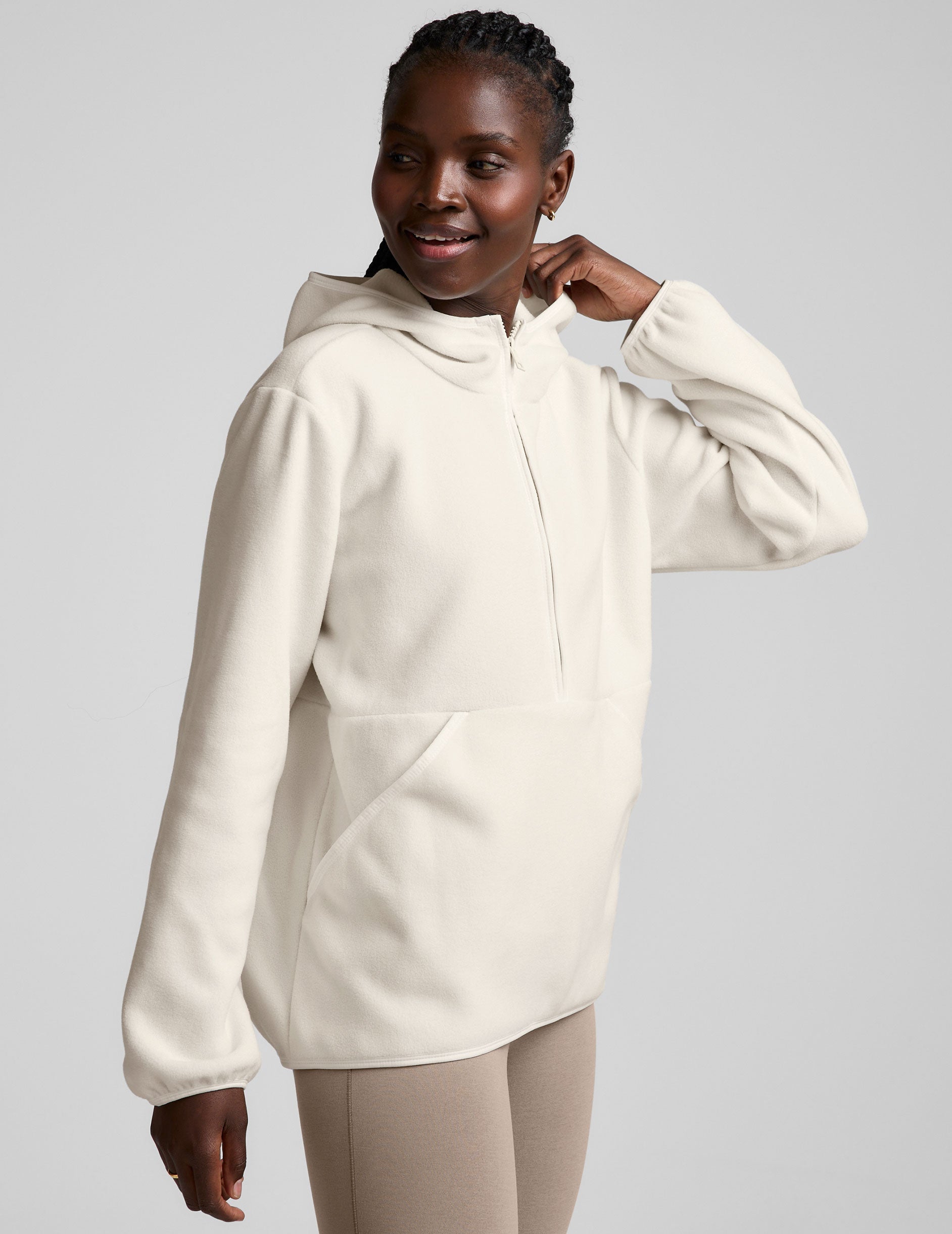 white fleece quarter zip jacket with a kangaroo pocket.