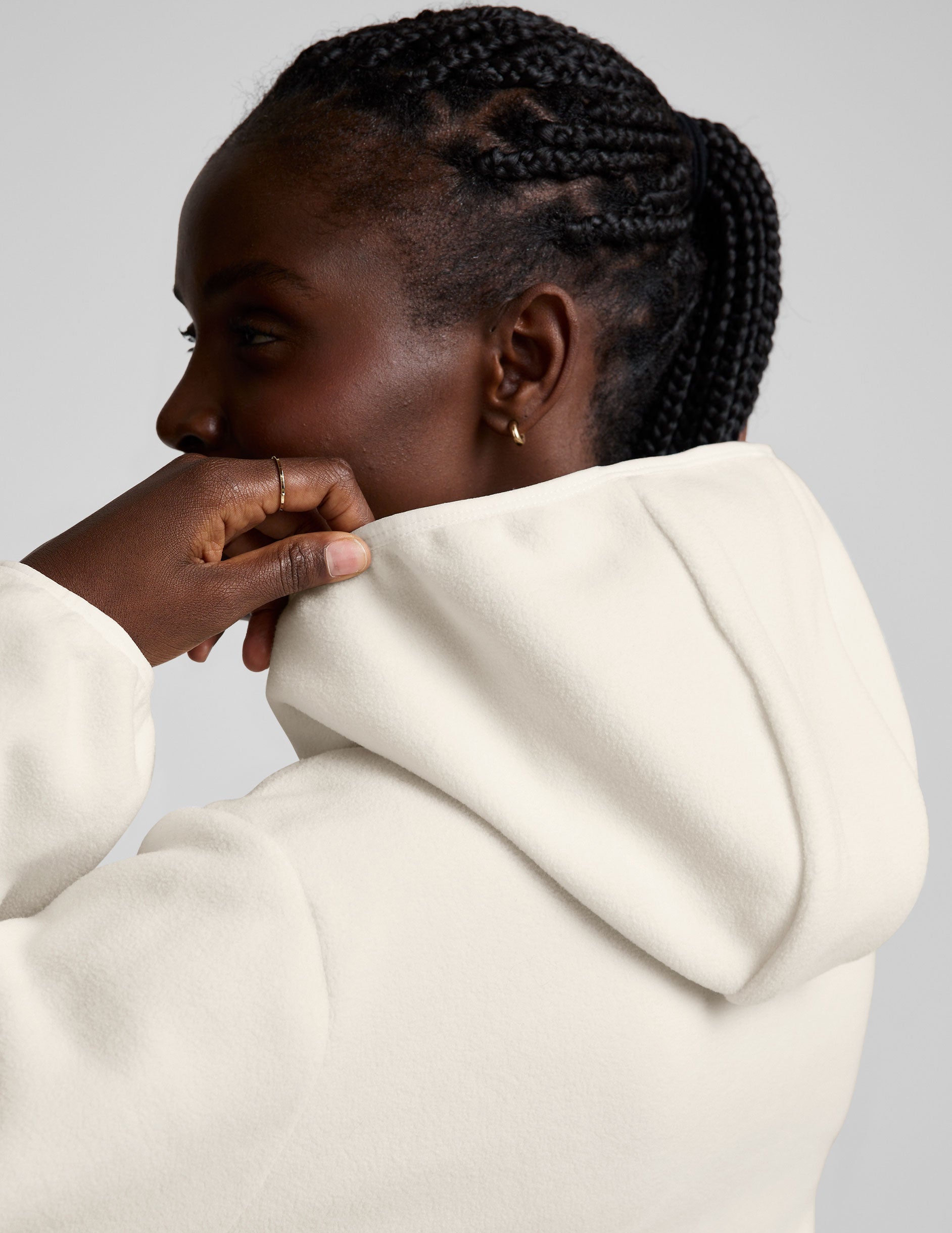 white fleece quarter zip jacket with a kangaroo pocket.