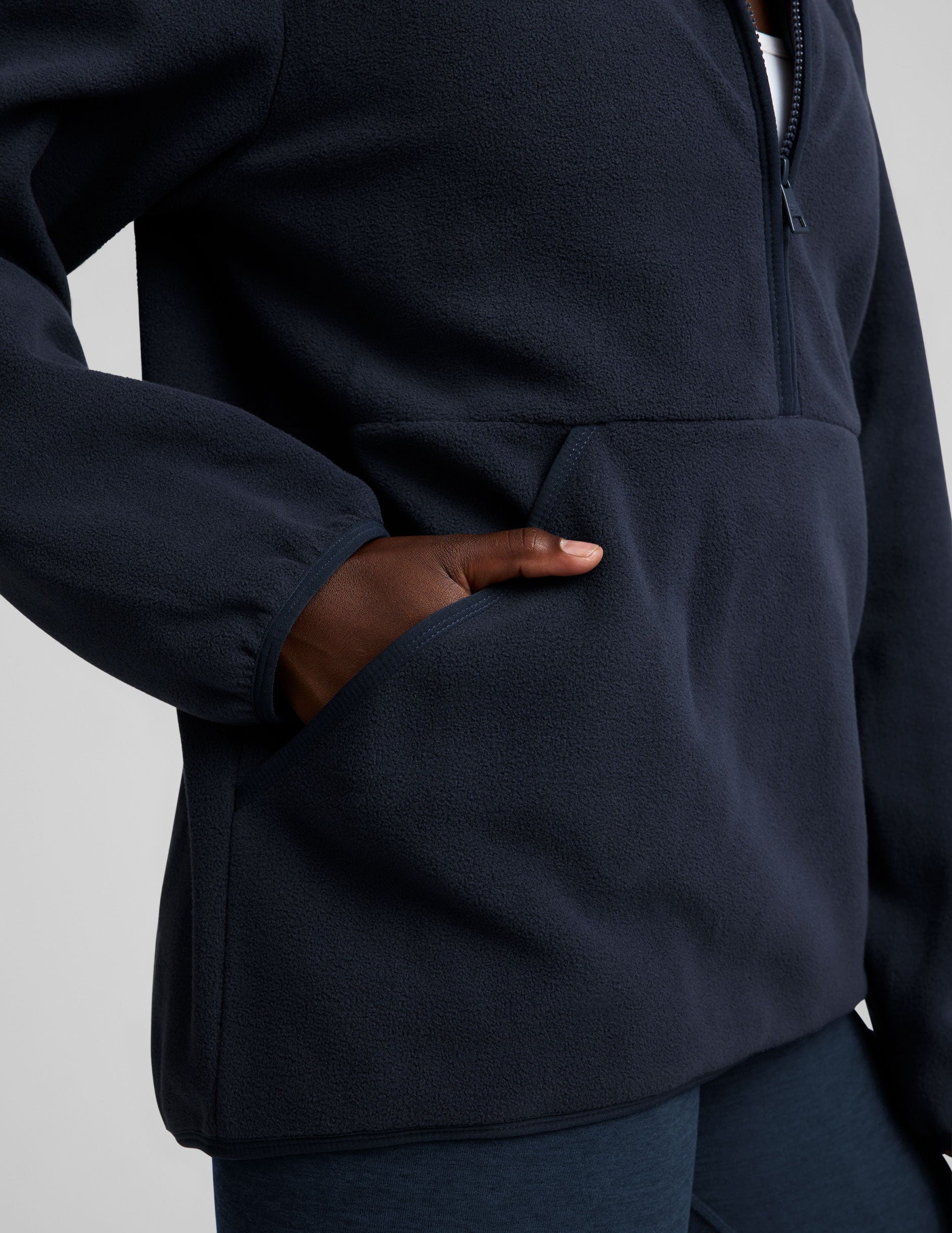 blue fleece quarter zip jacket with a kangaroo pocket.