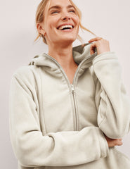white fleece quarter zip jacket with a kangaroo pocket.